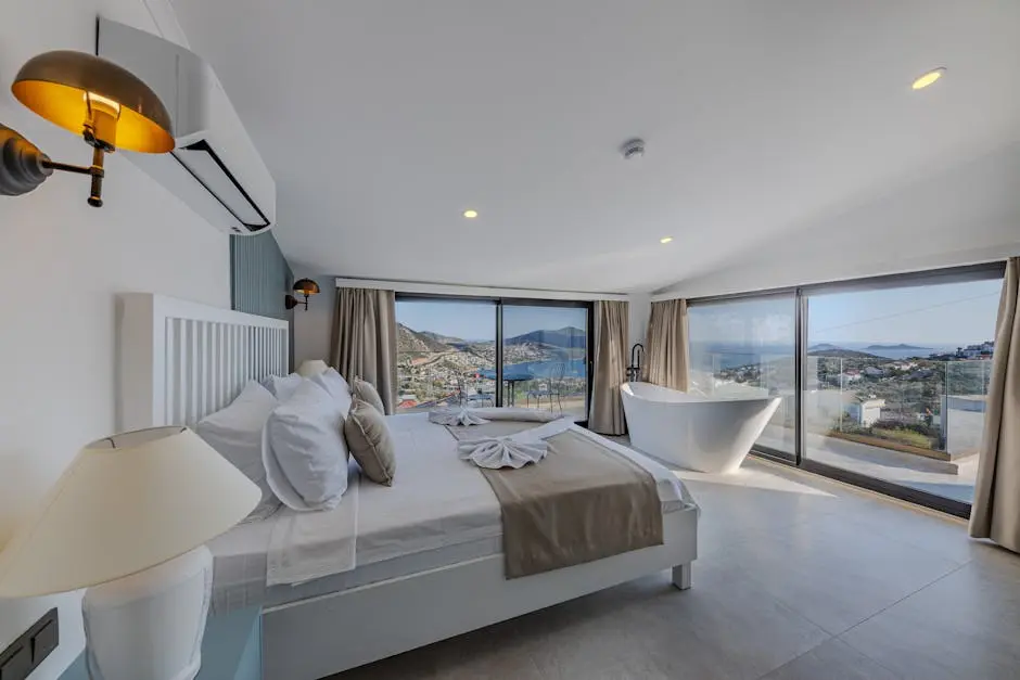 A bedroom with a large bed and a view of the ocean