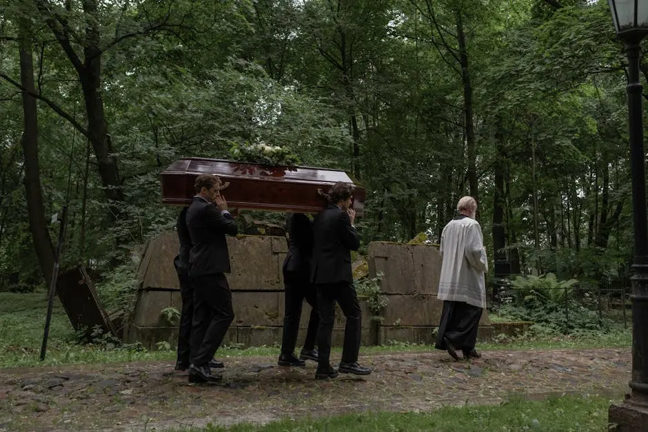 Men in Black Clothes Carrying a Coffin in a Cemetery