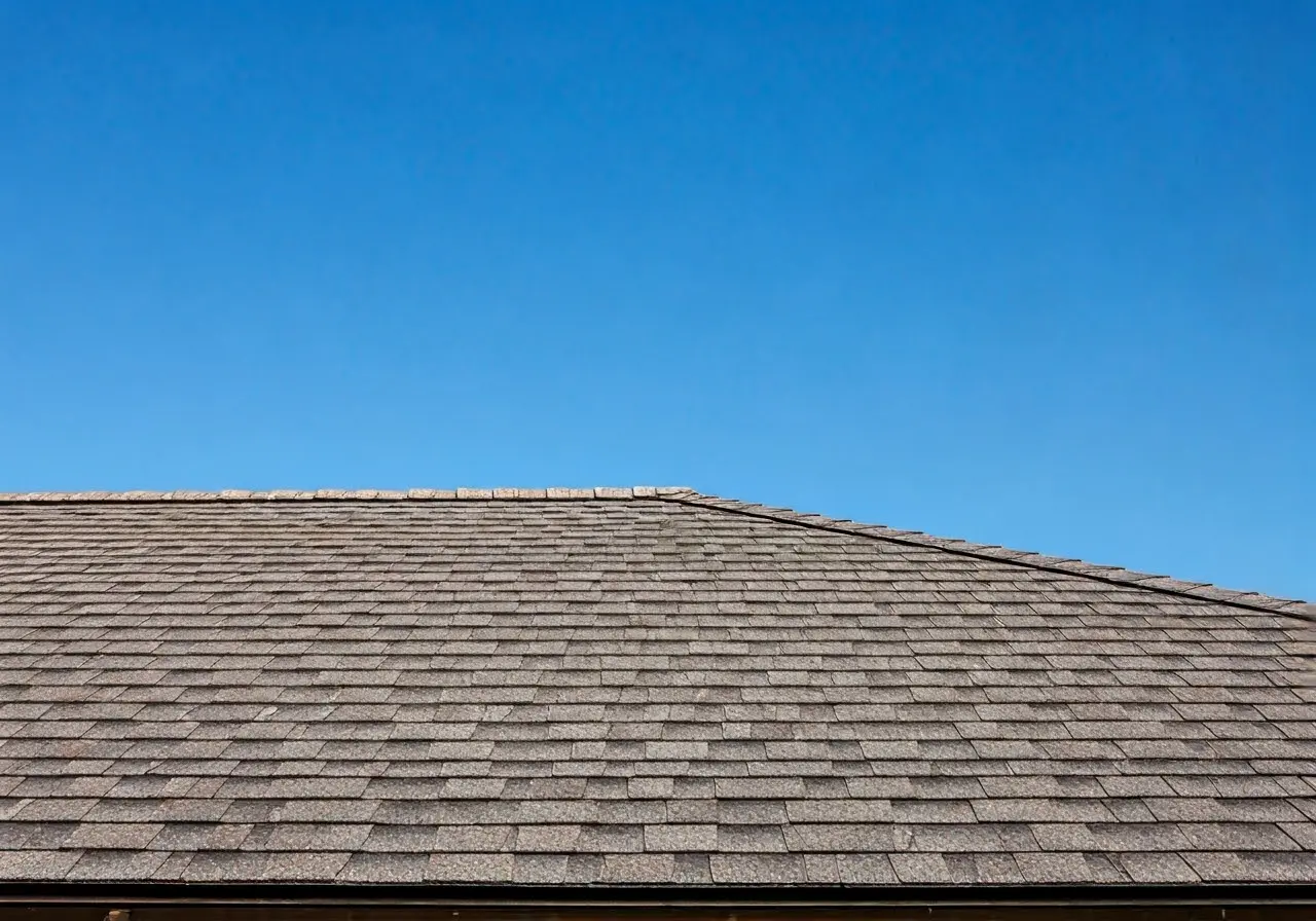 Close-up of a well-maintained shingle roof with blue sky. 35mm stock photo