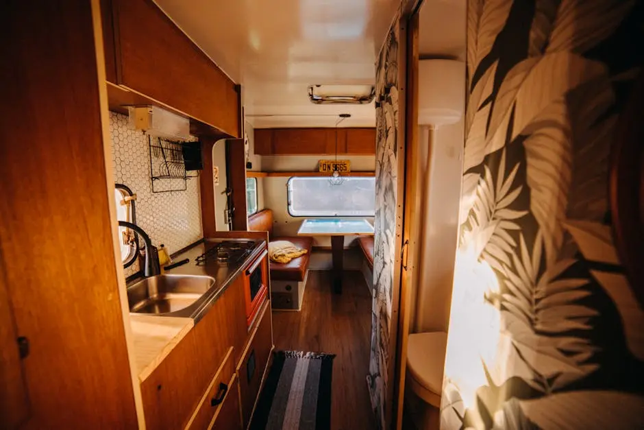 Warm and inviting camper kitchenette with retro decor, showcasing a cozy dining area and modern amenities.