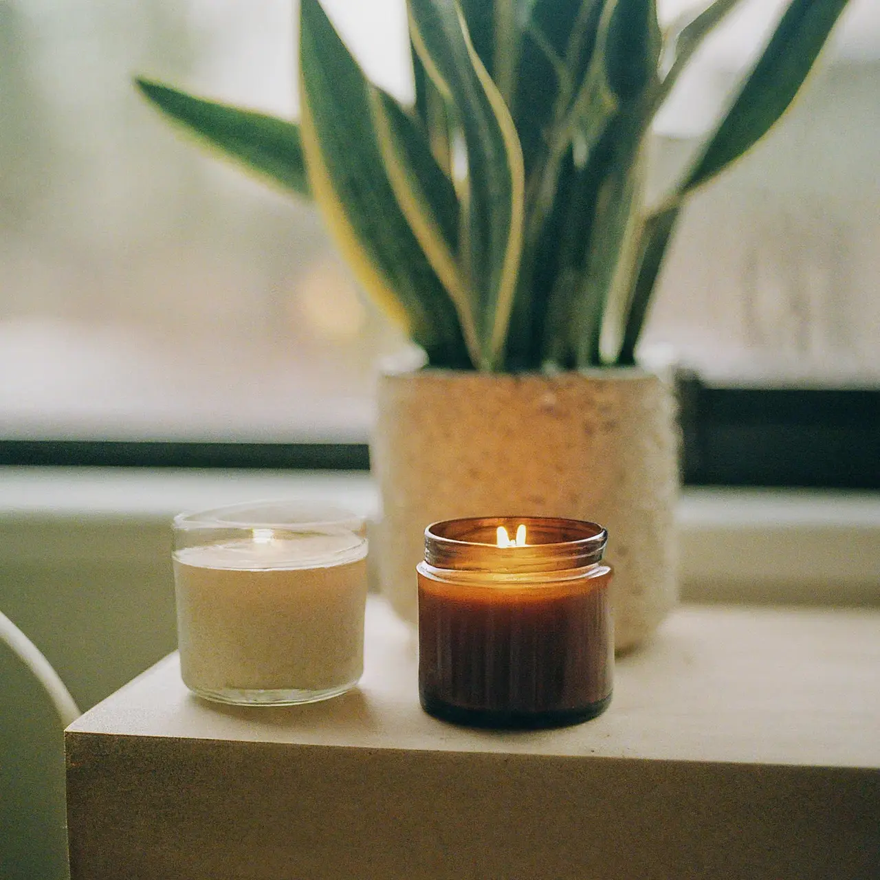 Aromatic essential oil candles on a cozy living room shelf. 35mm stock photo