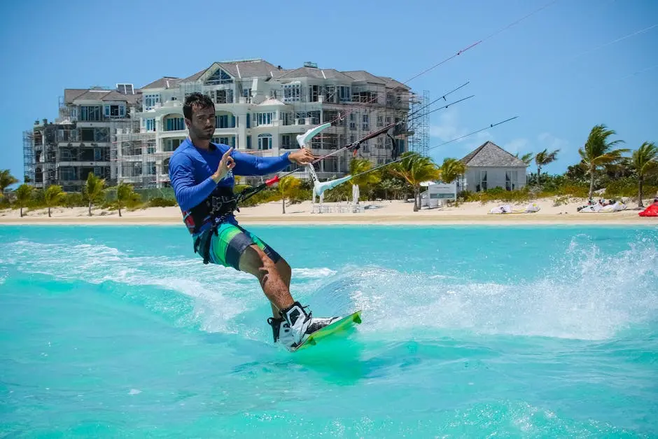 Dynamic kitesurfing scene with vibrant turquoise water and scenic beachfront resort.