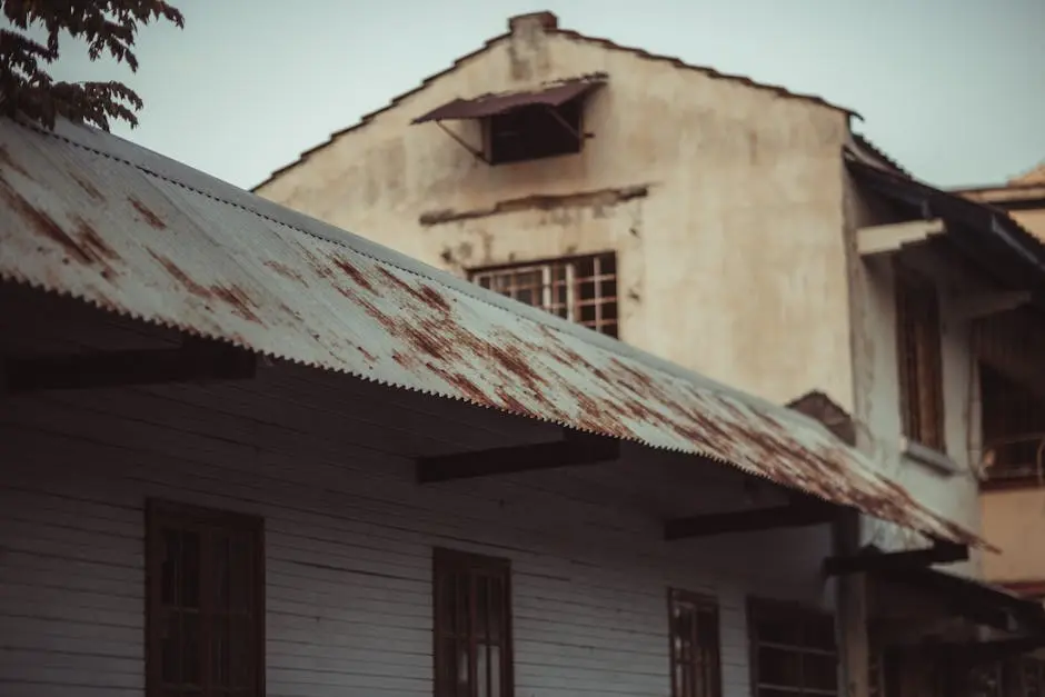 Aged building with a rusted metal roof, highlighting architectural decay.