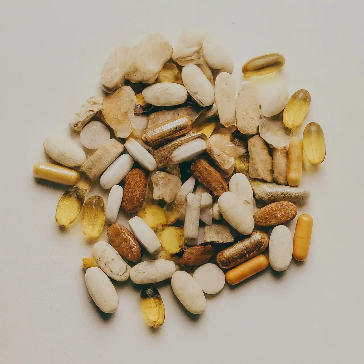 Colorful variety of vitamins and supplements on a white background. 35mm stock photo