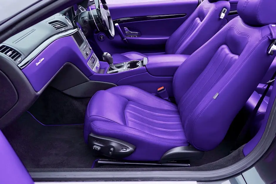 Vibrant violet leather interior of a luxury car, showcasing premium seats and dashboard in detail.