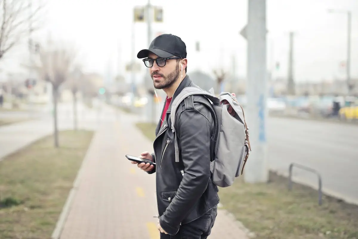 Man Wearing Black Leather Jacket and wearing a travel backpack for men that shows his style