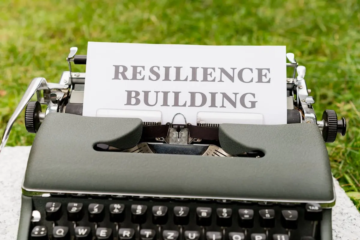 A typewriter with a paper that says resilience building