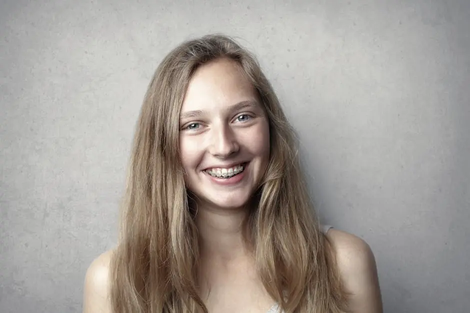 Portrait of a happy young woman with braces smiling at the camera.