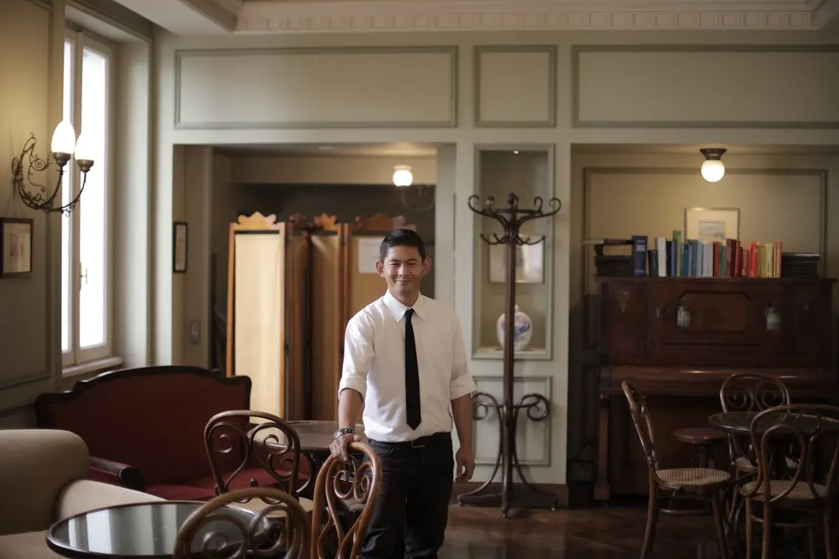 Cheerful restaurant manager looking at camera