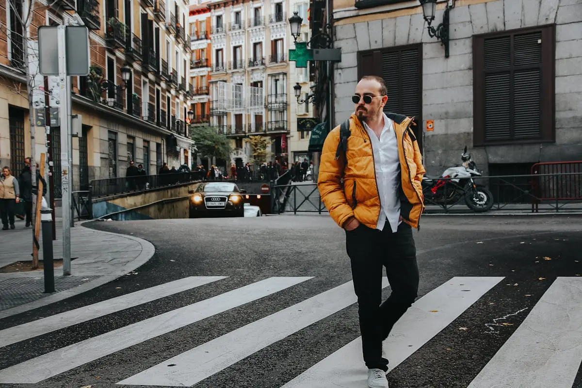 Photo of Man Walking on Pedestrian Crossing