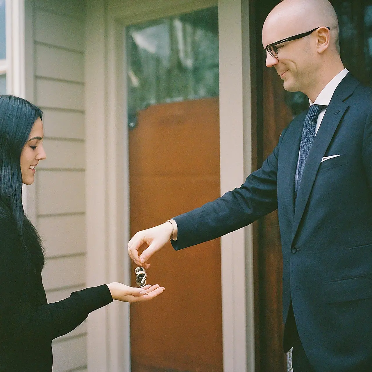 A property manager handing keys over to a homeowner. 35mm stock photo