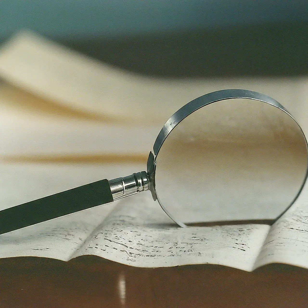 A close-up of a VTU transcript with a magnifying glass. 35mm stock photo