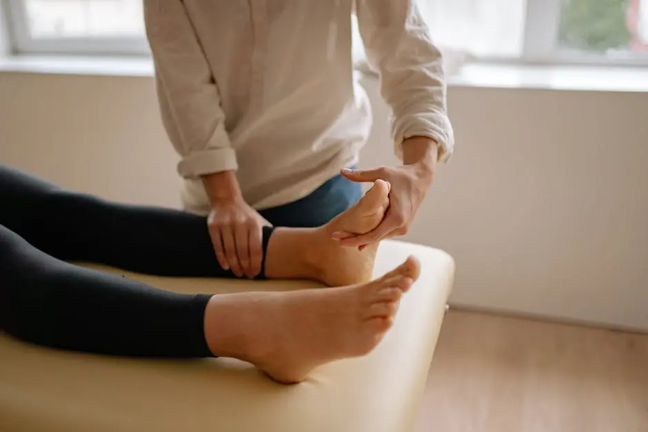 A Massage Therapist Massaging a Client’s Foot