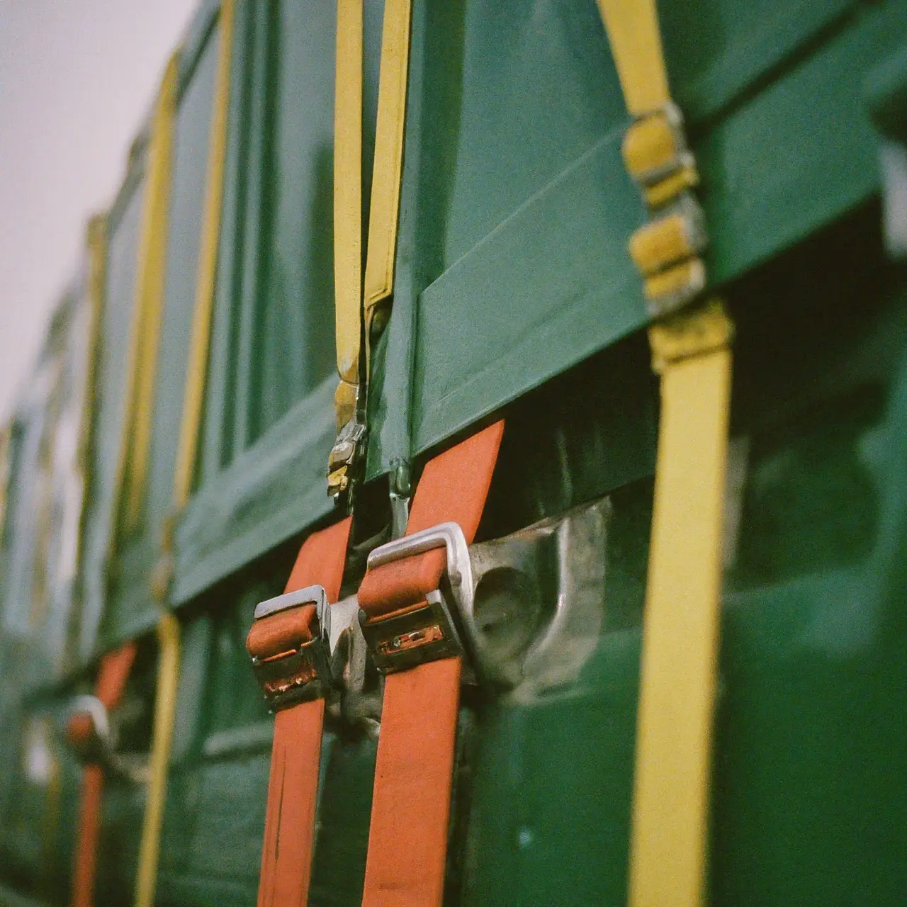 Close-up of colorful logistics straps and buckles on a truck. 35mm stock photo