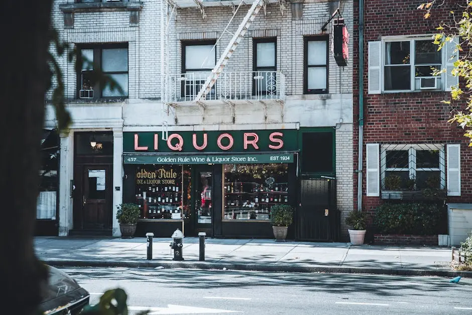 Vintage New York City liquor store facade with architectural details on a sunny day.