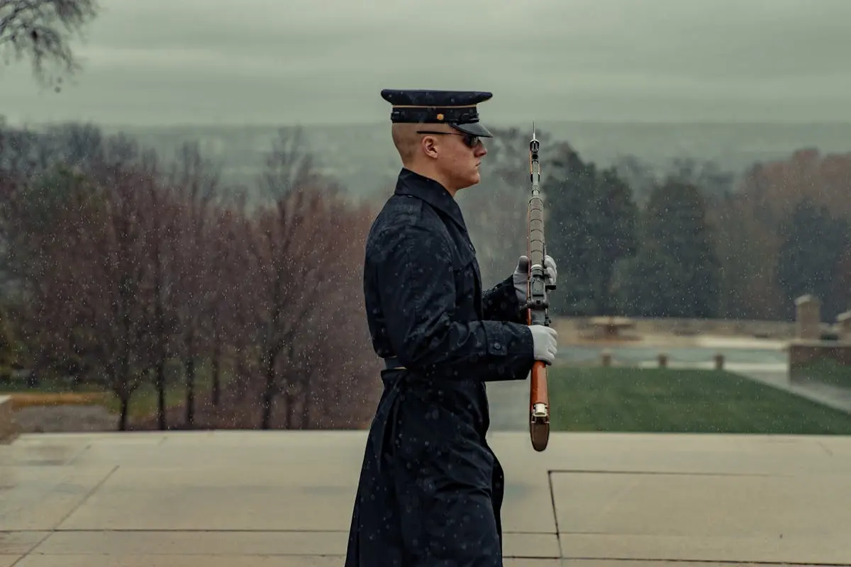 Focused soldier with rifle marching in park