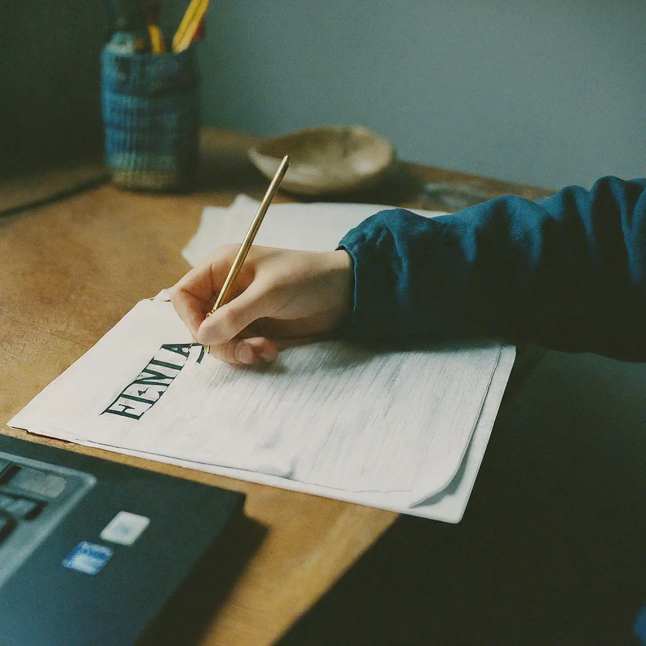 A person studying from a laptop with FEMA documents. 35mm stock photo