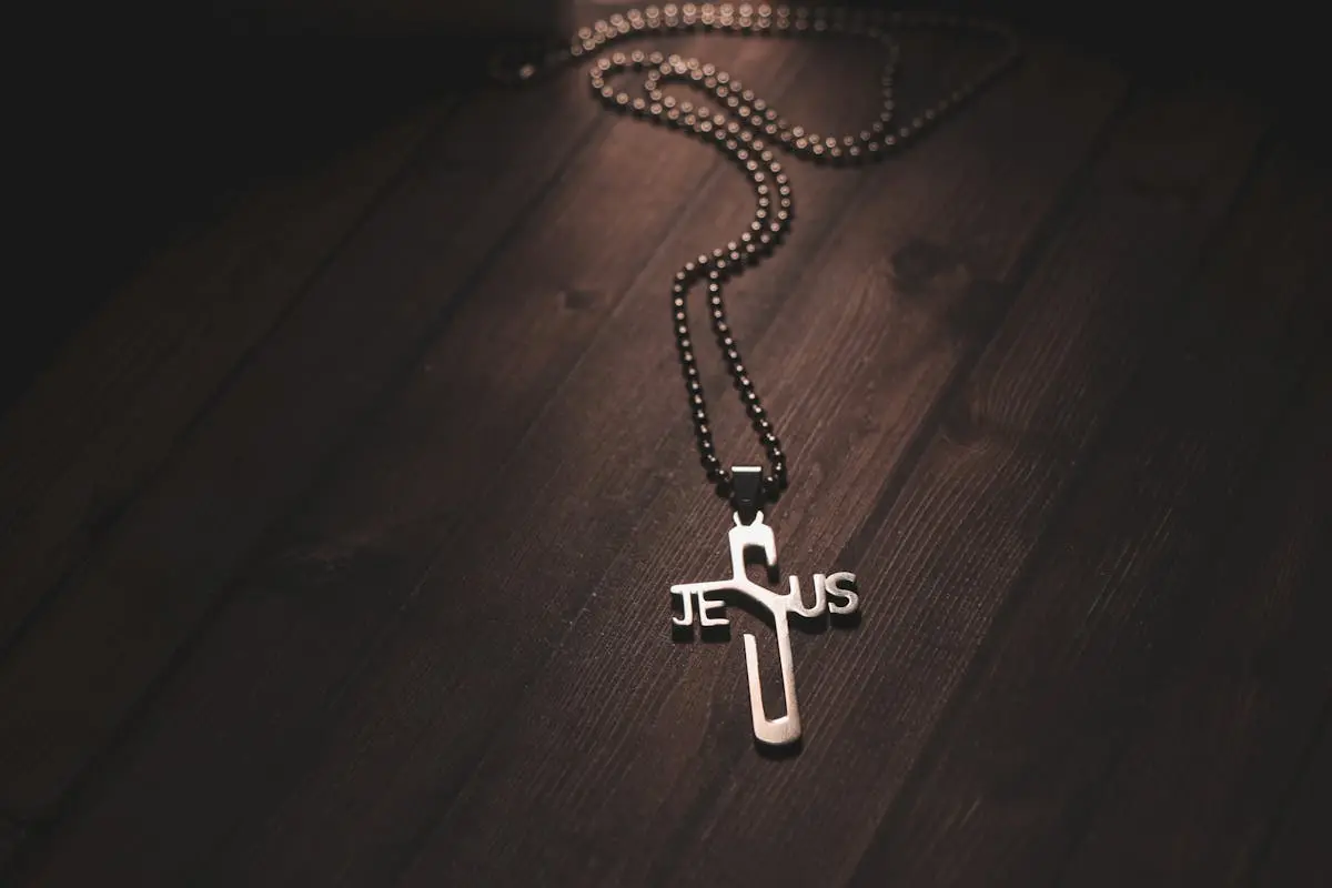 Necklace with Cross Pendant on Wooden Table