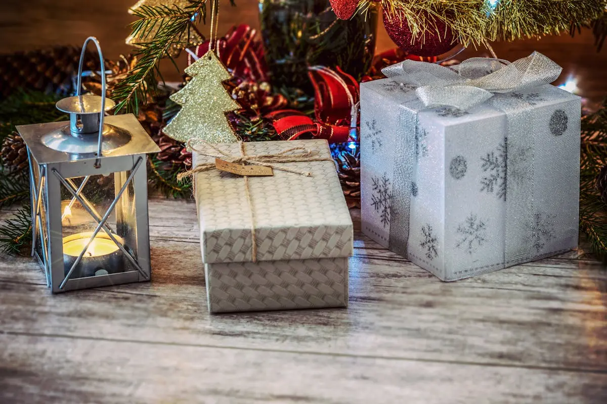 Festive Christmas scene with wrapped gifts, lantern, and holiday decorations.