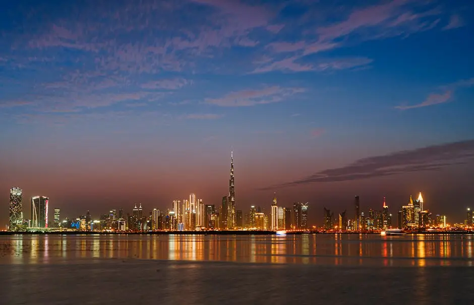 Scenic view of Dubai’s skyline at twilight with the iconic Burj Khalifa illuminated across the waterfront.