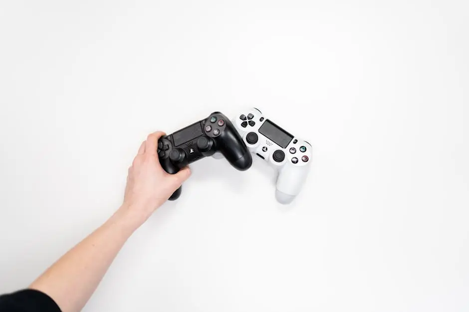 Black and white gaming controllers on a white background, emphasizing minimalism.