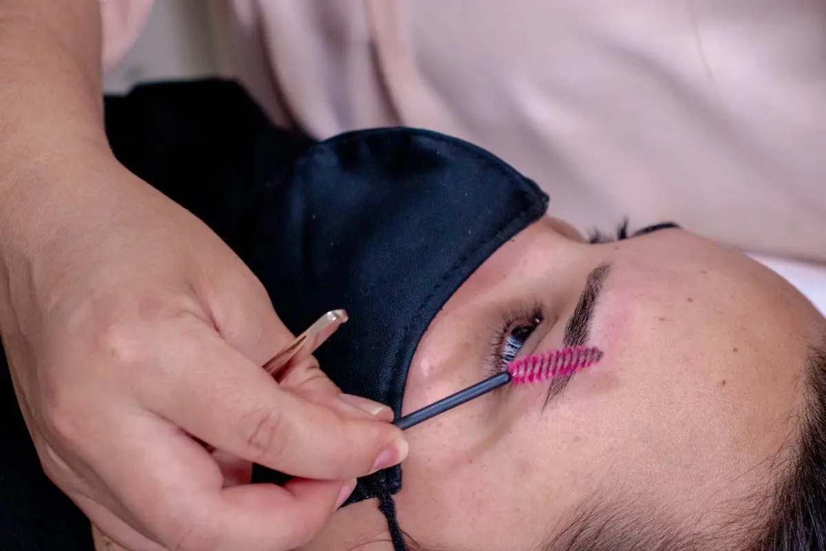 Beautician Painting Woman Brow with a Make-up Brush 