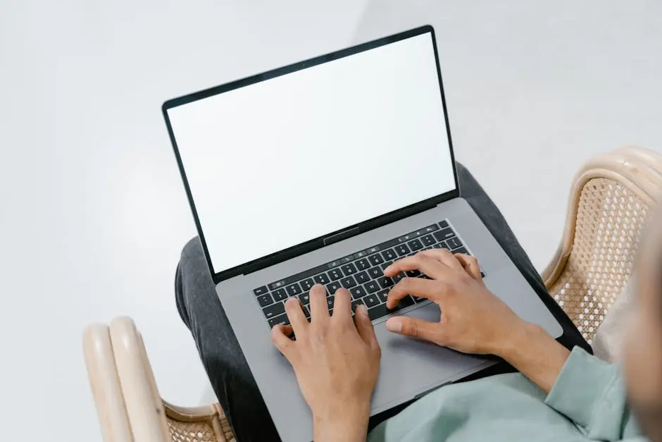 Photo of a Person Typing on a Laptop