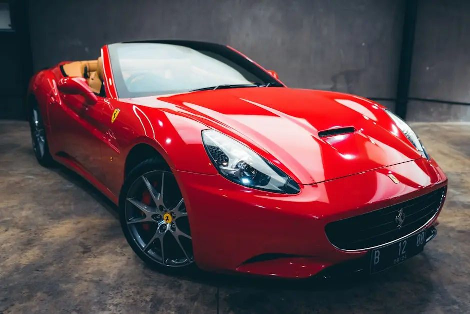 Expensive glossy red convertible with polished body parked in garage with concrete wall