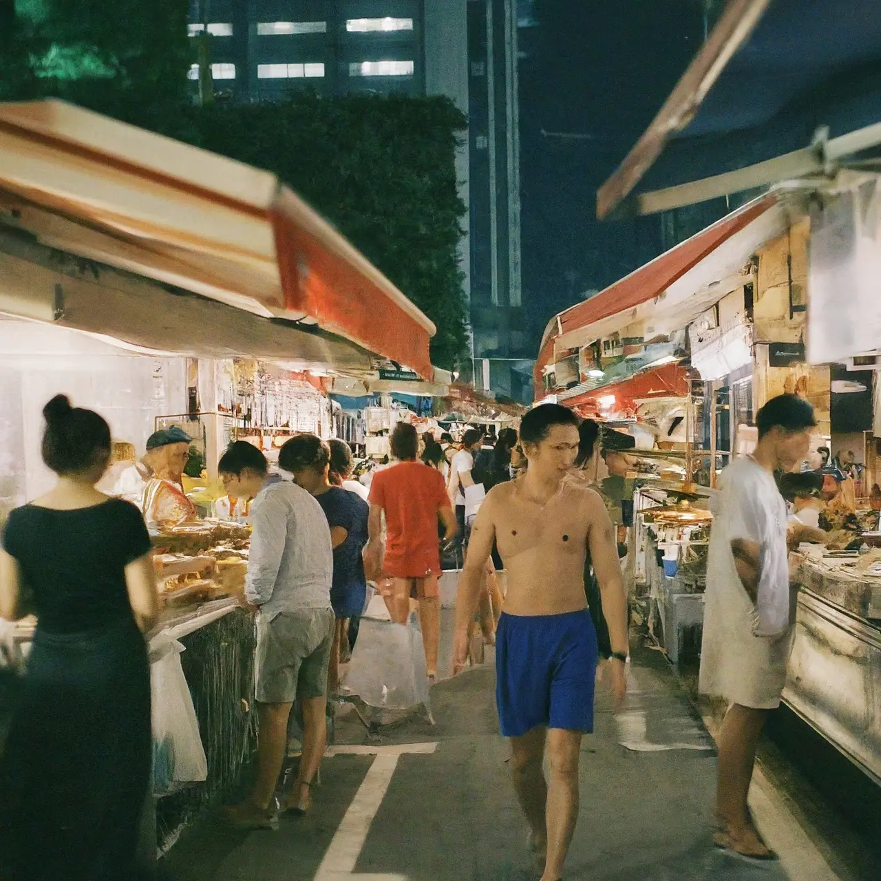 Bustling Singapore street food market at night. 35mm stock photo