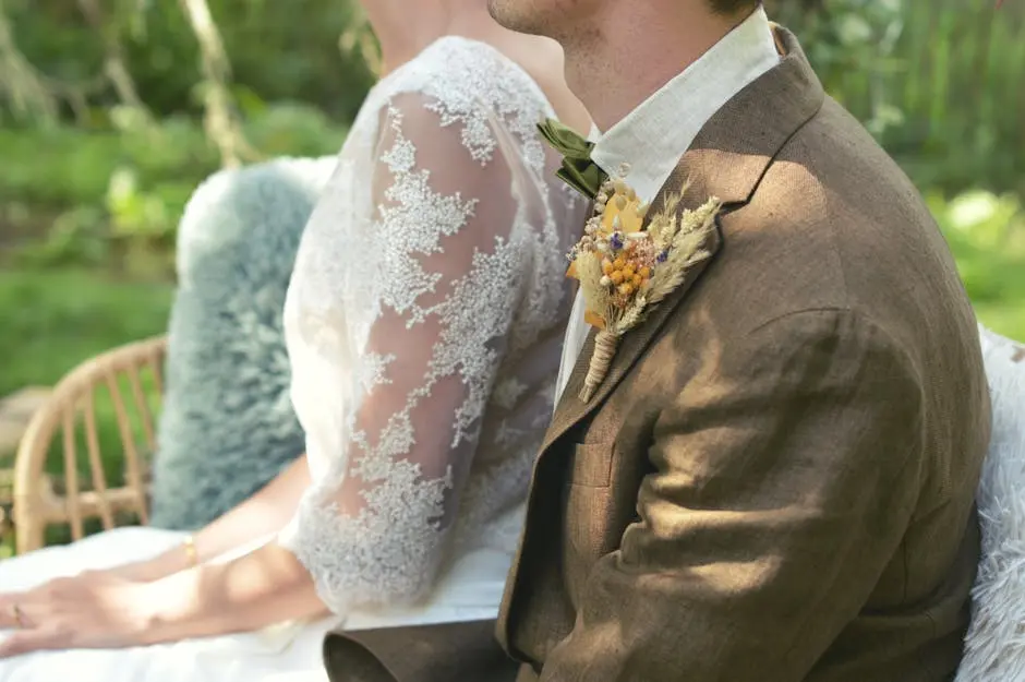 A bride and groom sitting on a bench in the garden