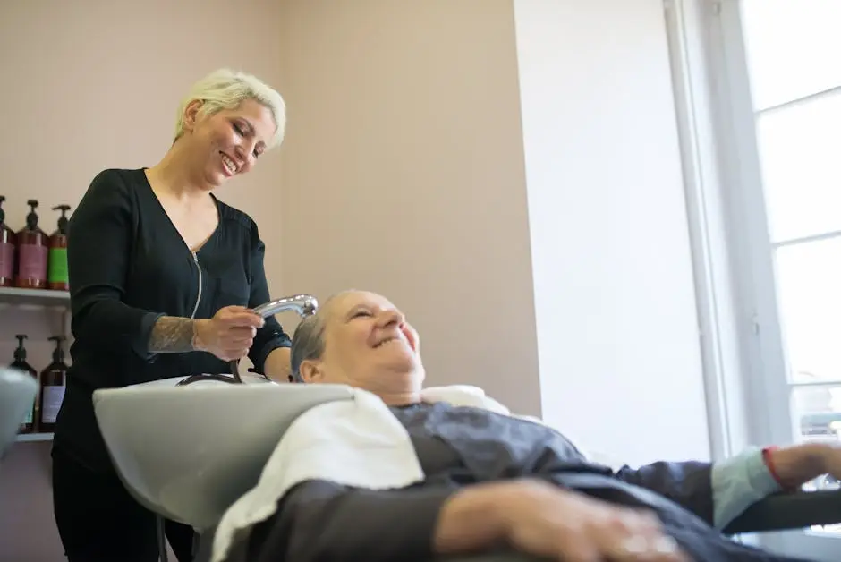 A hairdresser washes a client’s hair in a modern salon in Portugal, capturing a relaxed and cheerful atmosphere.