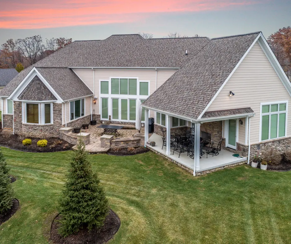 A beautiful home featuring a stylish patio with Elite Coatings, showcasing its durable, polished surface that enhances the outdoor living space with elegance and resilience.