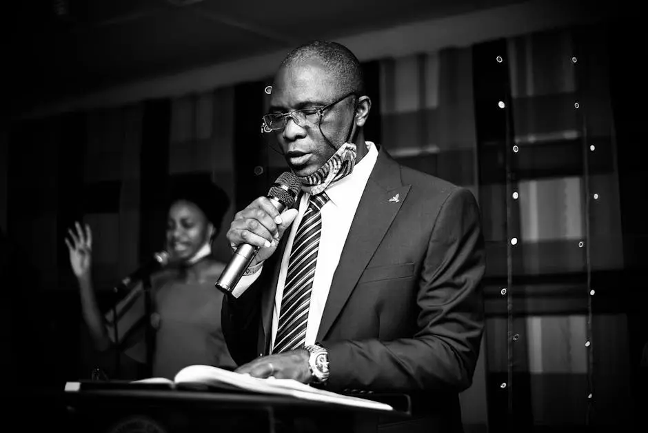 Man Holding a Microphone Reading a Book