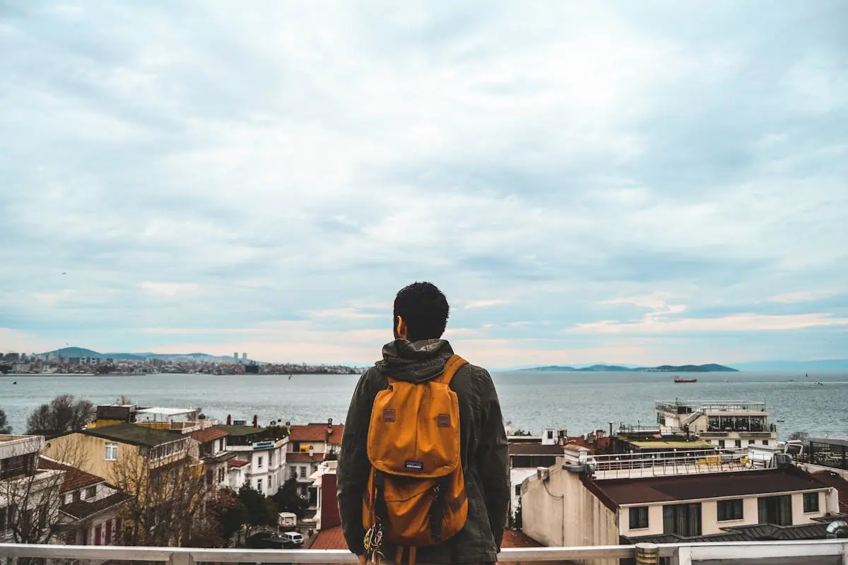 Man Wearing Black Jacket And Brown lightweight Backpack