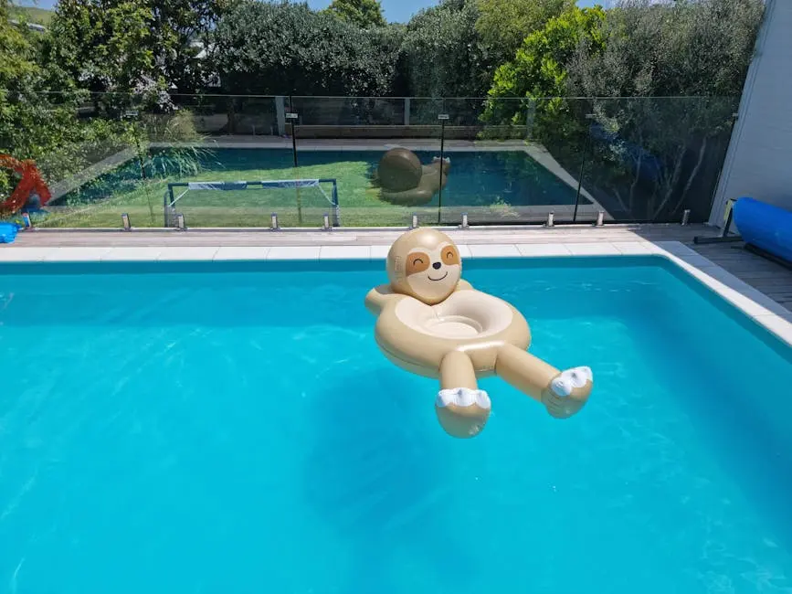 Inflatable sloth float lounging in a bright, blue swimming pool on a sunny day.