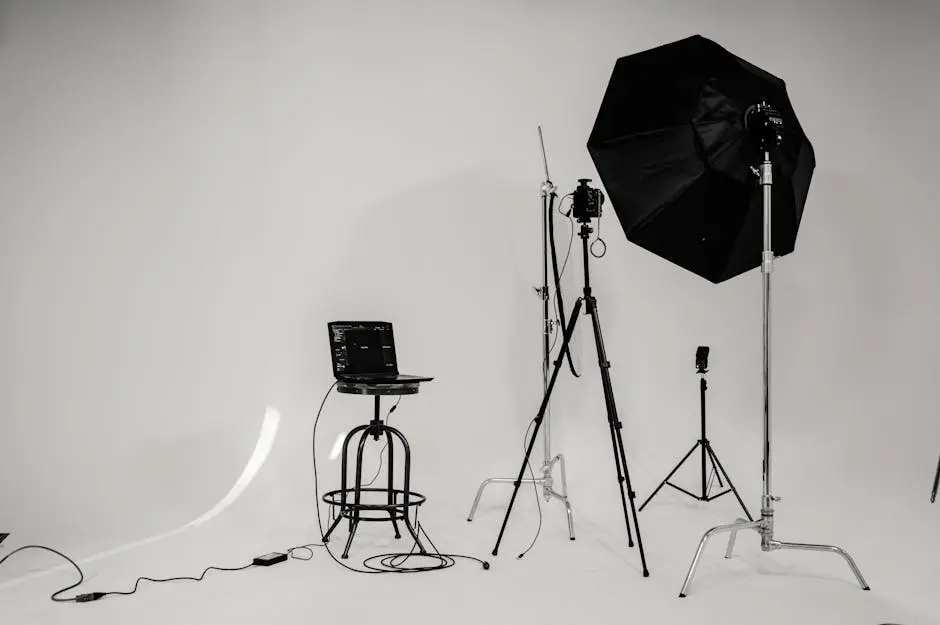 A black and white photo of a well-equipped photography studio with lighting equipment and tripods.