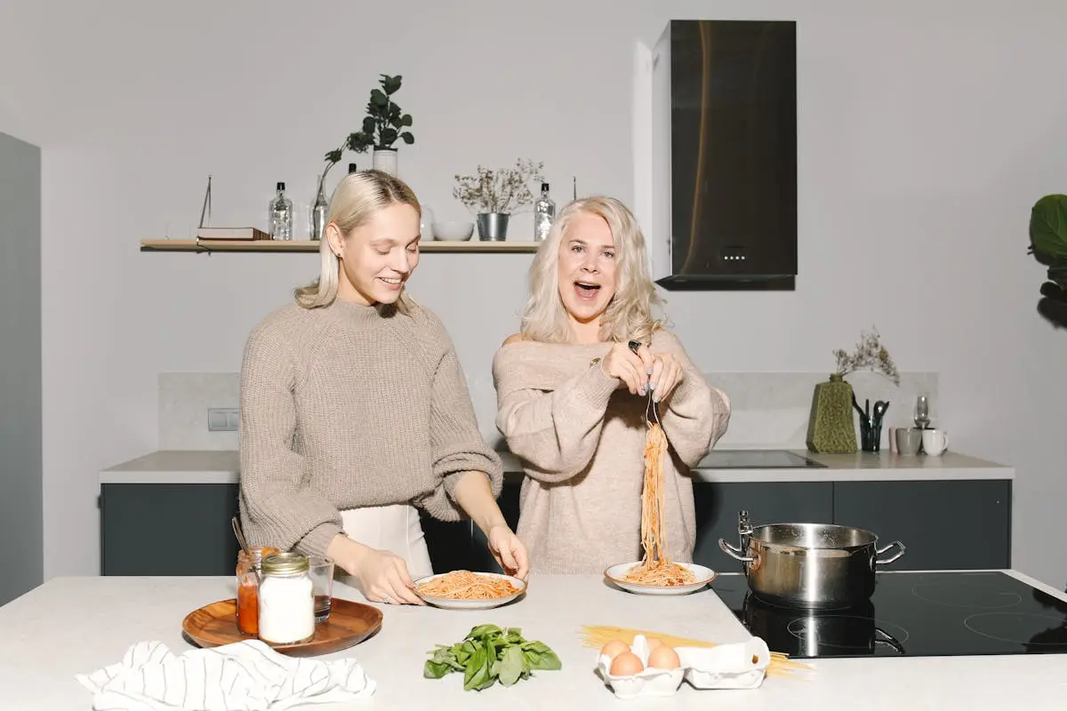 Mother And Daughter Having Spaghetti For Meal