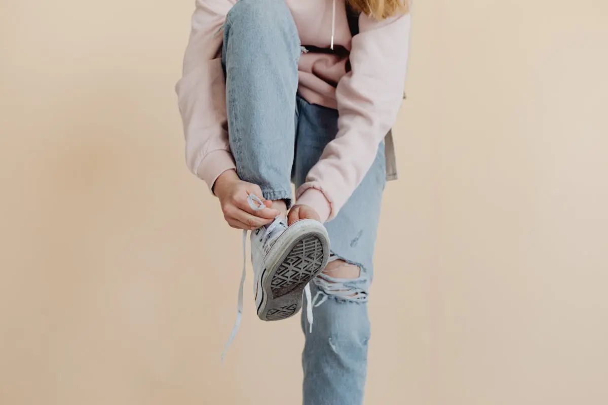 Studio Shoot of a Girl Tying Shoes