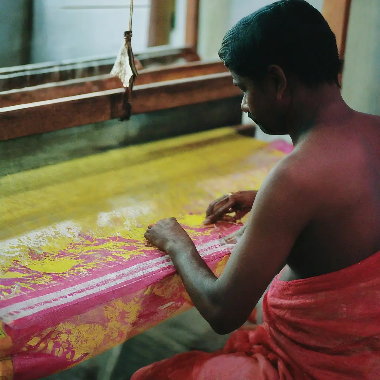 A weaver meticulously crafting a traditional Jamdani saree. 35mm stock photo