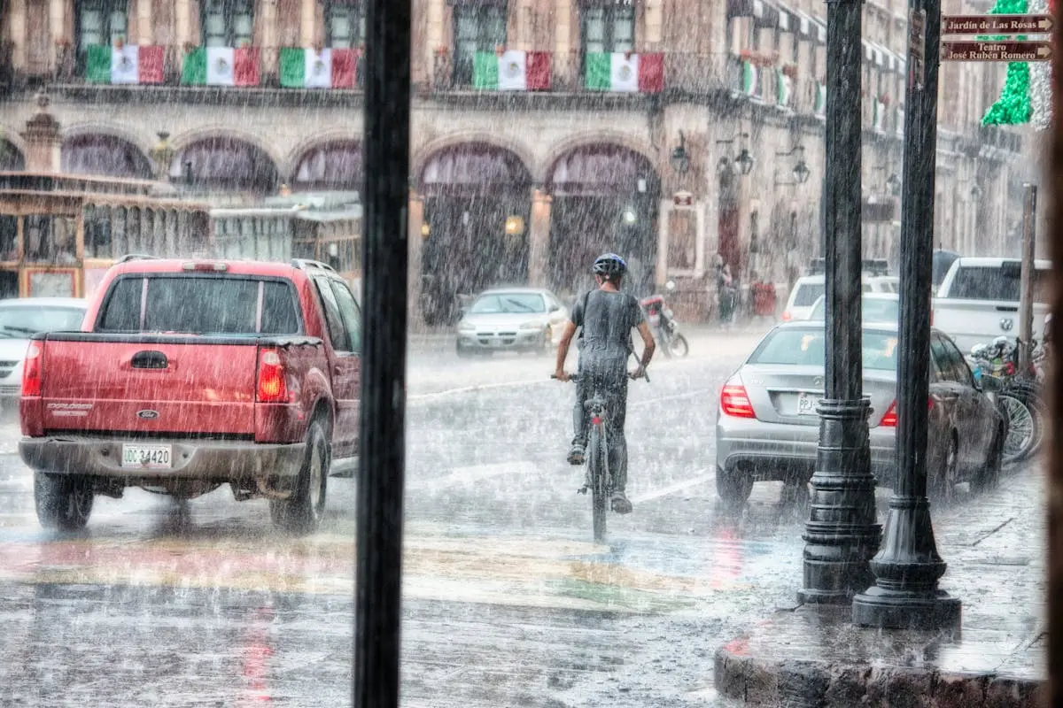 Person Riding a Bicycle during Rainy Day
