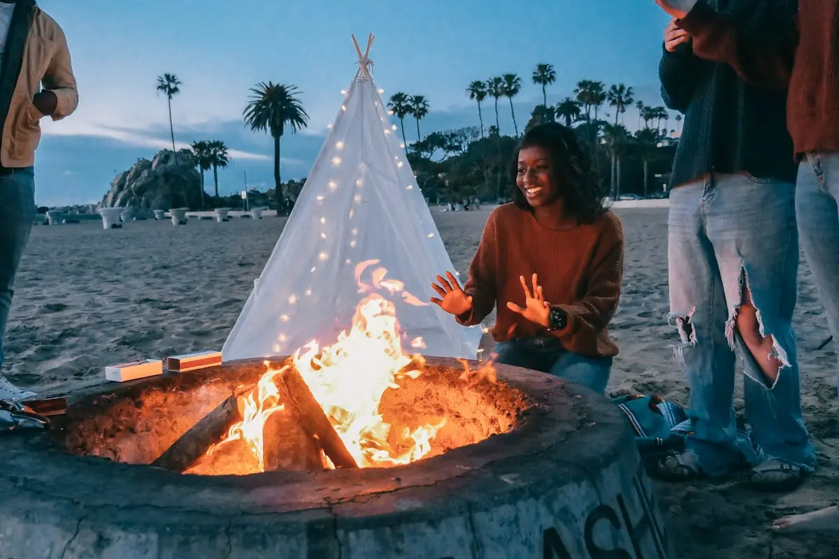 Woman Warming Her Hands in Front of the Fire Pit