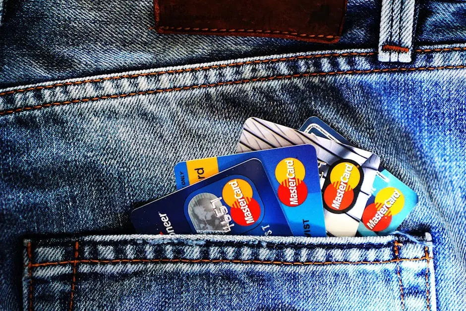 Close-up of a denim pocket with multiple credit cards, illustrating finance and fashion.