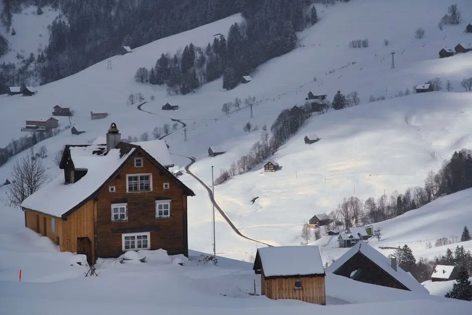 A house is sitting on top of a snowy hill