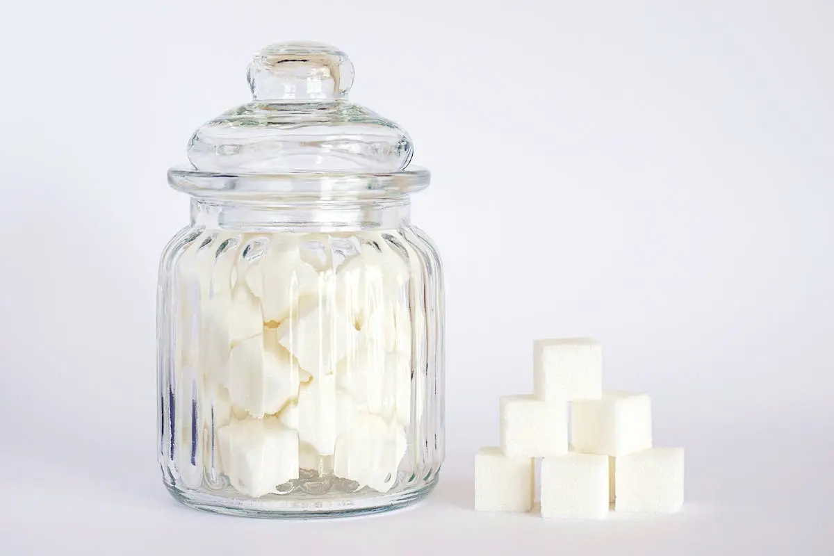 Close-Up Photo of Sugar Cubes in Glass Jar