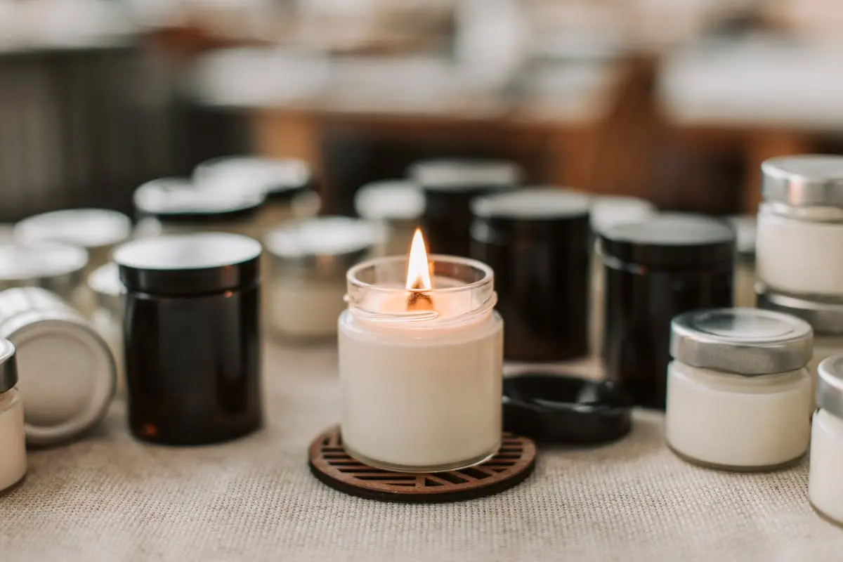 Close-up of a Burning Candle among Black and White Candles Standing on the Table 