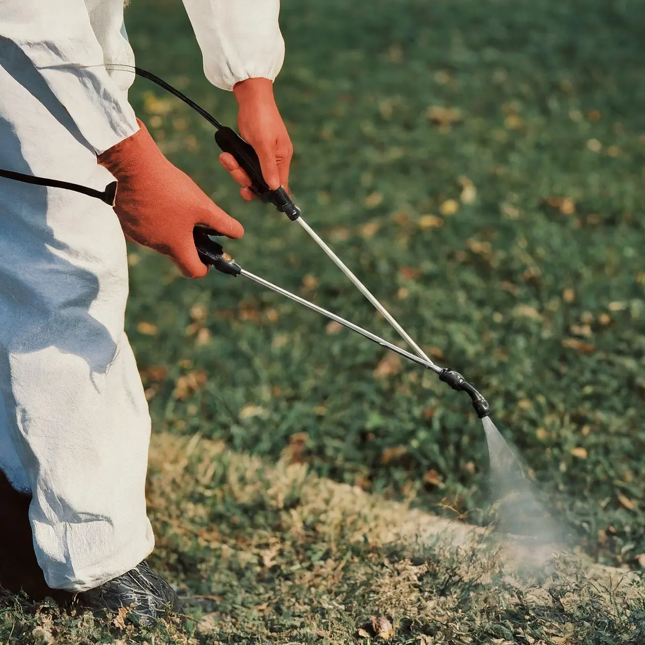 Close-up of a pest control worker spraying chemicals. 35mm stock photo