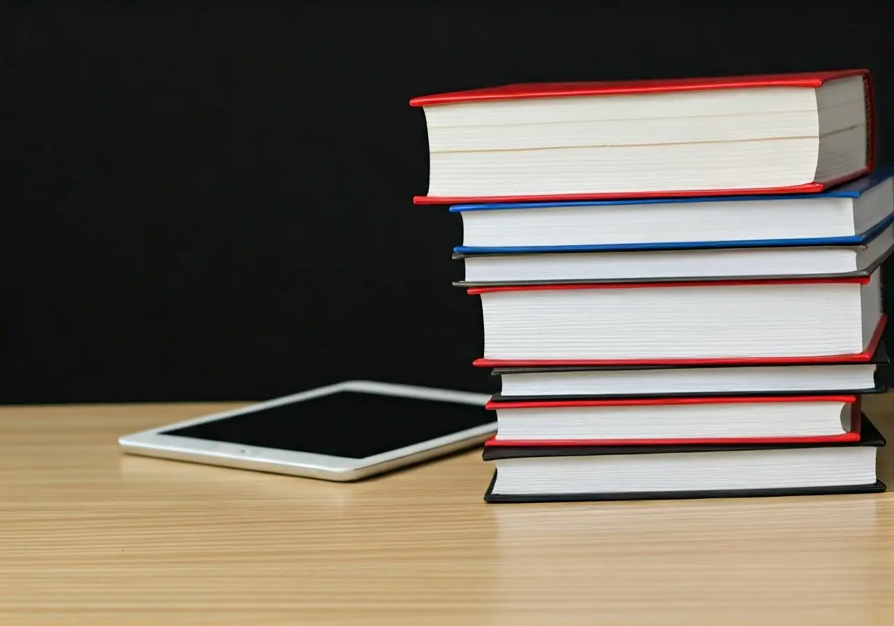 A stack of educational books and a tablet. 35mm stock photo