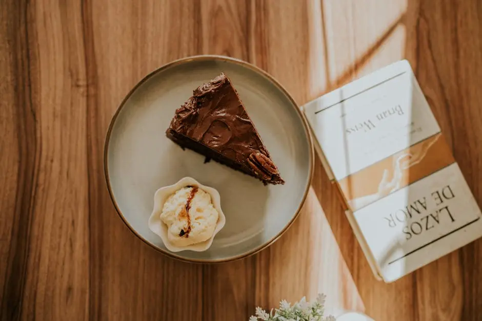 Cupcake and Chocolate Cake on Plate Next to Book on Table