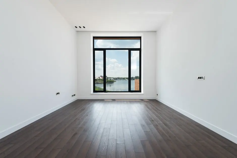 Interior of modern spacious light room with wooden laminate floor white walls and panoramic windows