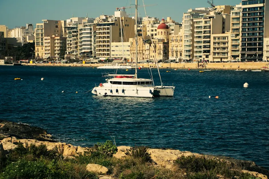 A luxurious yacht anchored on Valletta’s beautiful waterfront, showcasing the vibrant cityscape.